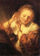 REMBRANDT Harmenszoon van Rijn Young Woman Trying on Earrings France oil painting artist